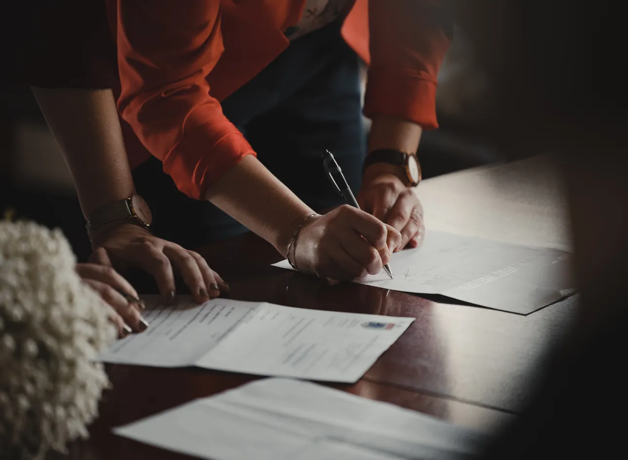 A business owner reviewing commercial lease documents at a desk — representing the key clauses commercial tenants must understand before signing