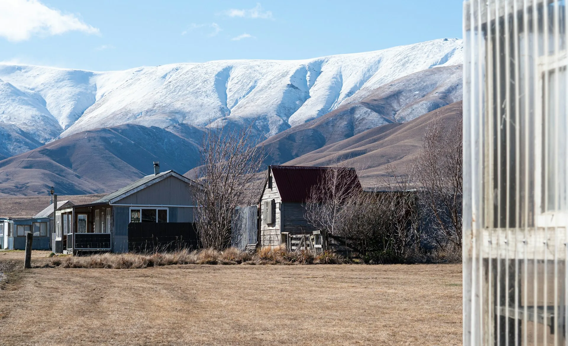 Scenic New Zealand residential neighbourhood with hills and blue sky in the background
