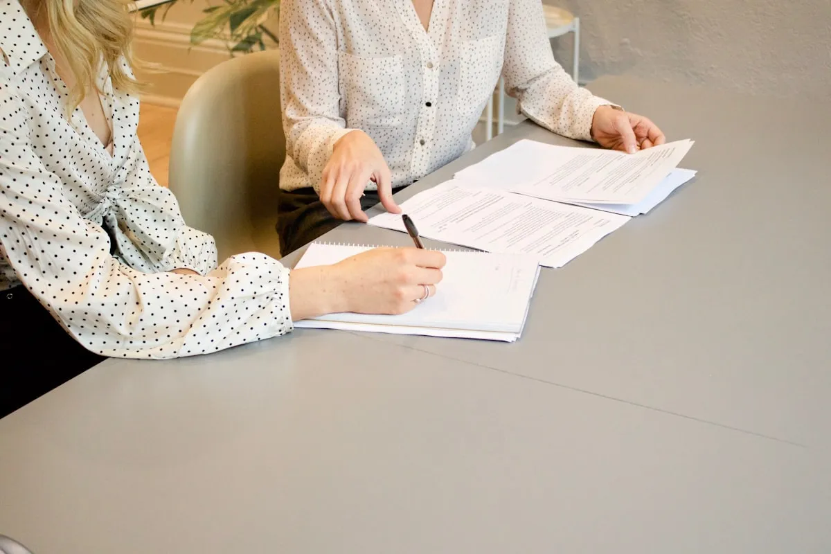 Two people reviewing property documents together at a desk