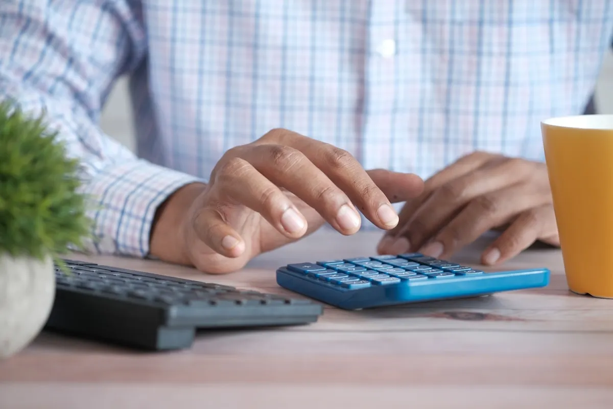 Working through the numbers on a calculator