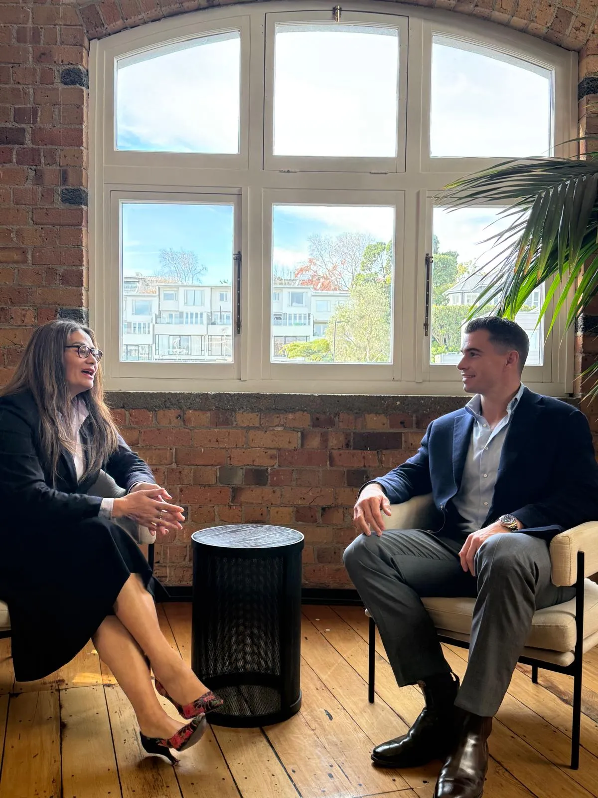 Two people in conversation at NZ Legal's office