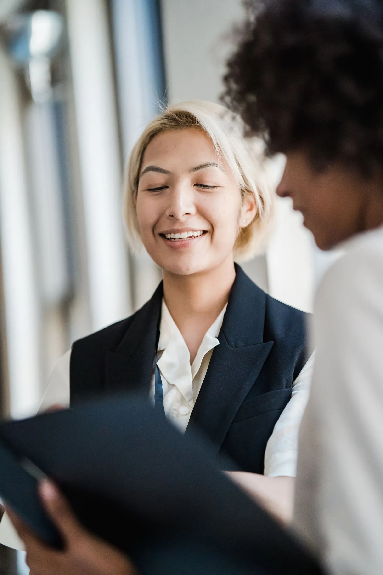 A lawyer and client reviewing paperwork together, both smiling