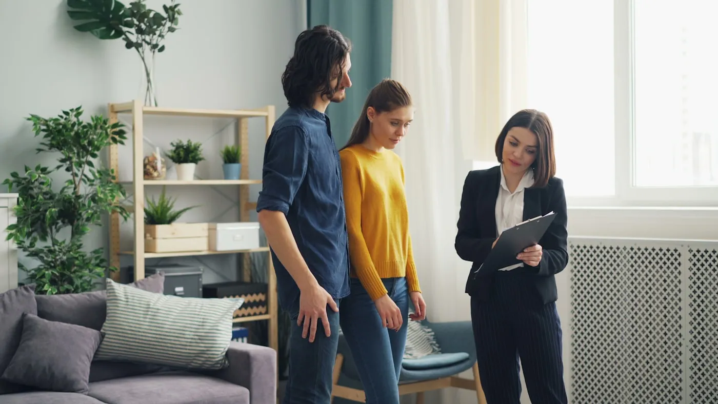 A real estate agent walking a couple through a home viewing