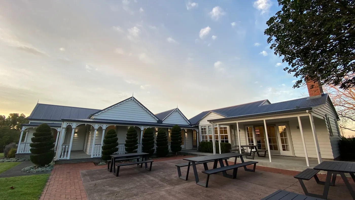 An older character weatherboard home with a decorative veranda